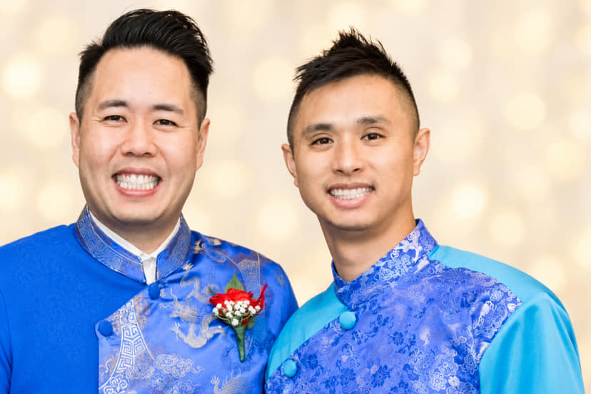 Tony and Ken, the two cousins behind Li Xi Games, smiling side by side in blue áo dài.